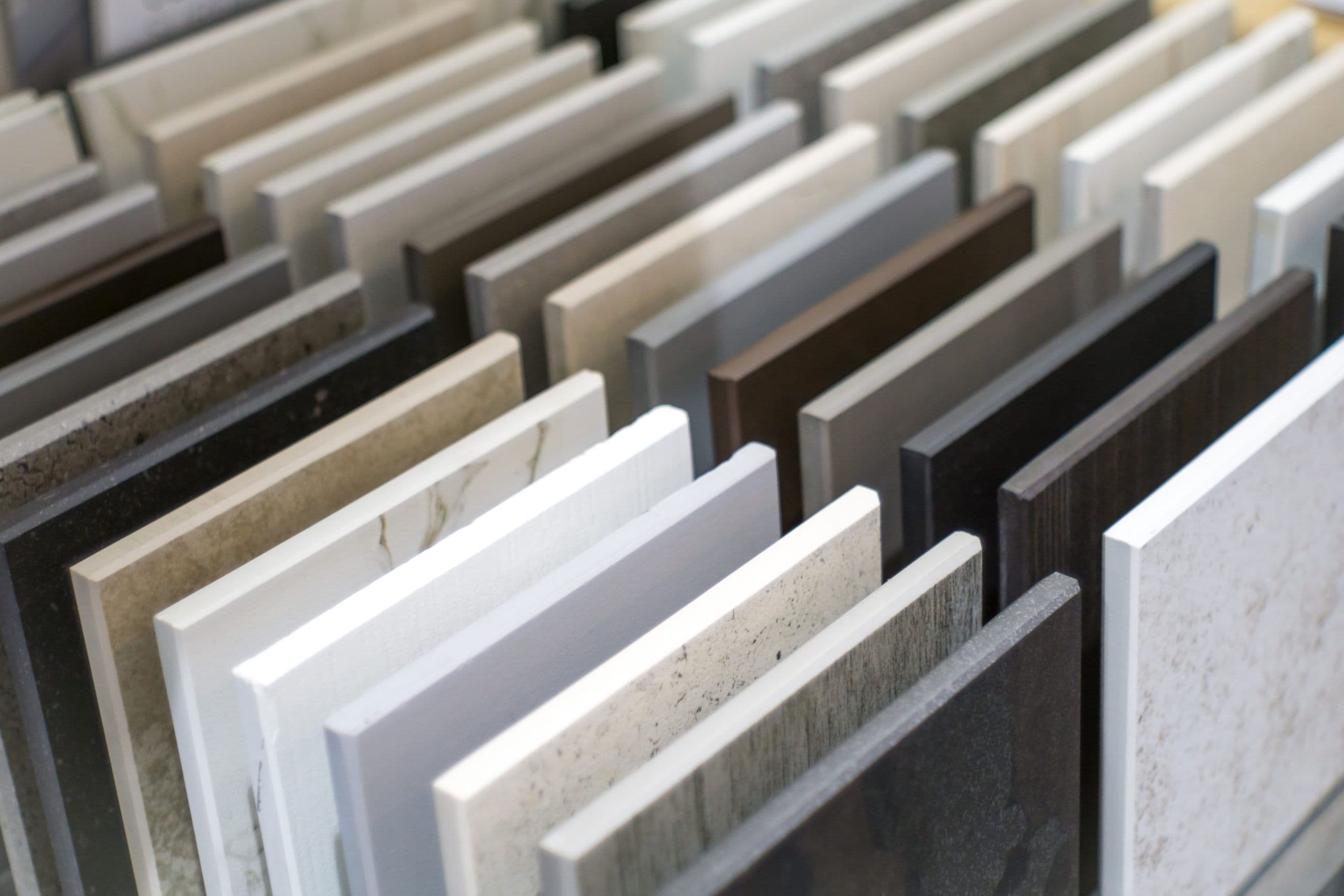 Stone and composite benchtop samples upright in a display rack